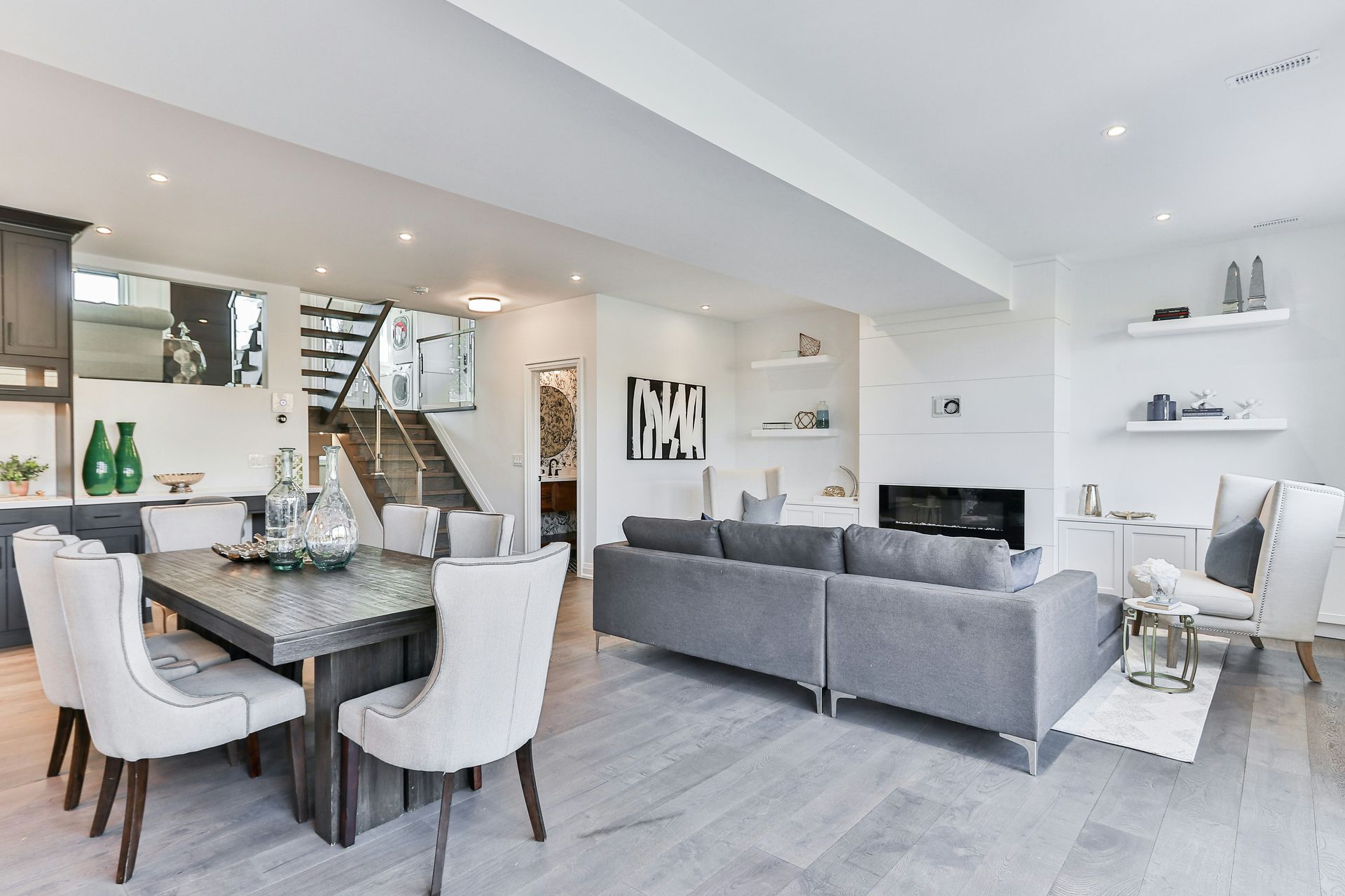 A dining table and grey sofa in an open plan living room